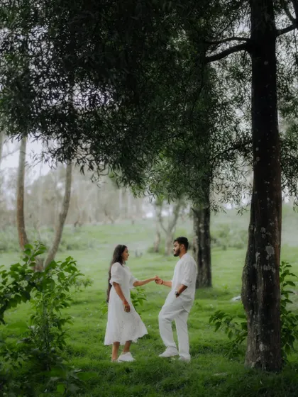 A romantic, dreamy photo of a couple dancing in a misty, green forest in Ooty, perfect for a hill station pre-wedding shoot.