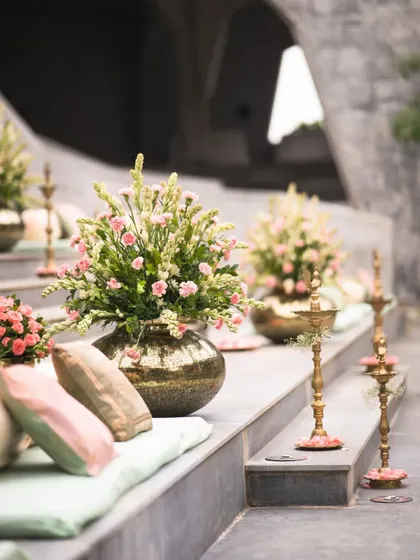 The aisle is the first step into your new life together. We lined these grand venue steps with floral arrangements and traditional brass lamps, creating a beautiful and welcoming path for the couple and their guests.