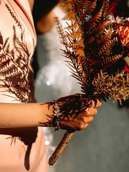 A detail shot focusing on the shadow of the bridal bouquet against a bridesmaid's dress. It's all about finding beauty in the light.