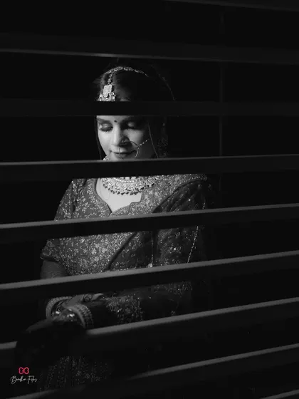 A beautiful black and white bridal portrait, using the shadows from blinds to create an artistic and mysterious effect.