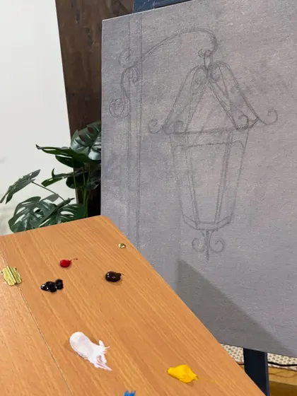 The start of a new painting. Here you can see the initial pencil sketch of a street lamp on the canvas, with the first dabs of paint on the palette, ready to bring it to life.