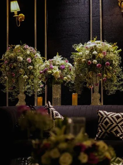 A view of the lounge seating, showing how large floral arrangements are used to soften the space and add a touch of natural elegance.