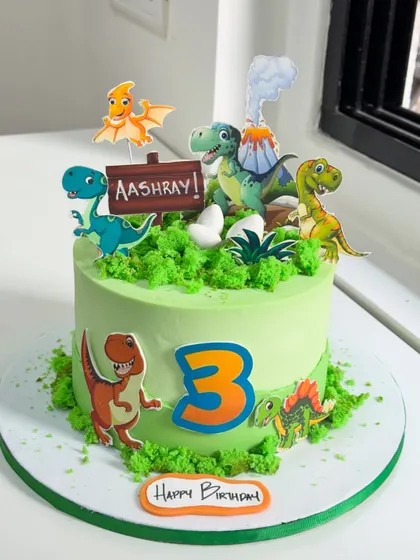 A simple plan turned into a Jurassic adventure! This dinosaur-themed cake for a 3rd birthday is filled with happy dinos, a volcano, and lush green textures to create a prehistoric world.