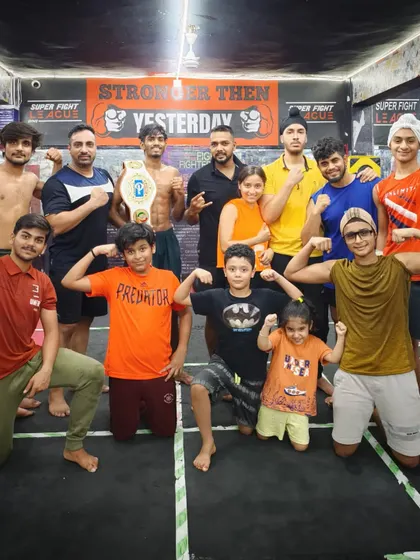 Attitude toh hamare khoon mein hai. The team posing with a championship belt.
