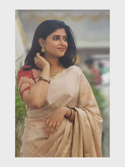 A candid shot in a simple and elegant beige saree.