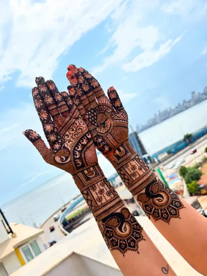 A gorgeous bridal mehendi with the Mumbai sea link in the background. The design features elegant elephants and peacocks, blending traditional art with the modern vibe of a city wedding.