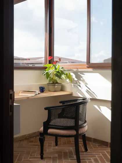 We carved out a small outdoor study nook off the primary bedroom. The brick herringbone floors and simple wooden desk create an earthy, inspiring spot to work or read.
