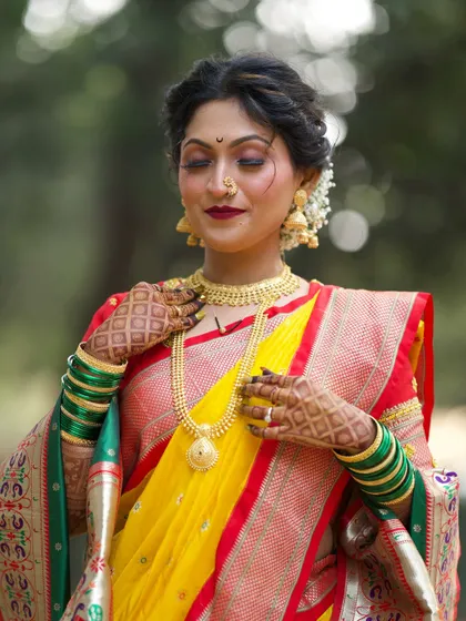 A serene and beautiful shot. The bride's eyes are closed, drawing attention to the flawless eyeshadow and her calm expression before the wedding festivities.