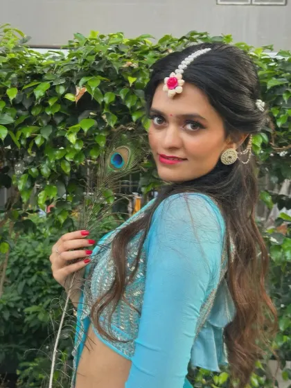 A close-up shot with a peacock feather, a symbol often associated with Lord Krishna, who is a central figure in many semiclassical dance stories.