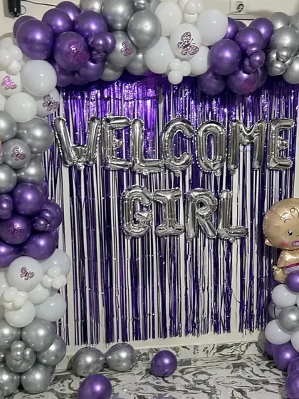 A 'Welcome Girl' decoration setup with a purple and silver theme, perfect for celebrating the arrival of a new baby.