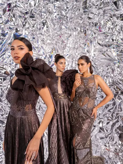 A high-fashion campaign shoot for Kalki Fashion. I styled three models in coordinated metallic and textured gowns against a silver foil background, creating a futuristic and glamorous editorial look.
