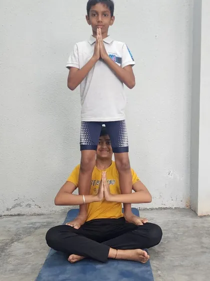 This pose demonstrates the strength of the base and the balance of the flyer, all while maintaining a calm, centered posture.