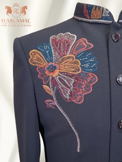A close-up of the multi-colored floral embroidery on the chest of the dark grey Indo-Western sherwani.