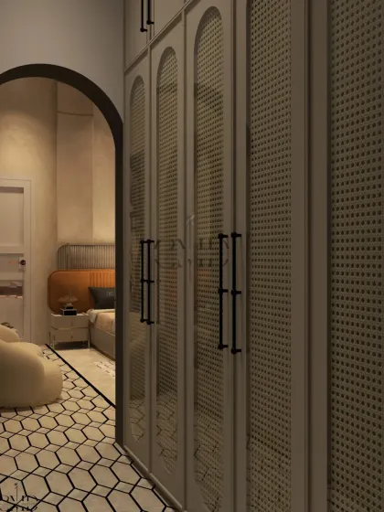 The entrance to the walk-in wardrobe features curved PU-painted shutters with chic cane detailing, continuing the room's elegant design language.