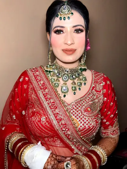 A close-up of the bride's makeup, highlighting the flawless base and the intricate details of her jewelry.