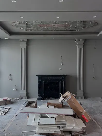 The Gulshan Dynasty living room during the construction phase, with the fireplace and pillars installed but awaiting finishing.