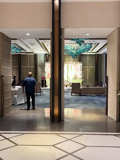 A view from the entrance into the main ballroom at Crowne Plaza. The floral stands at the doorway give guests a hint of the beautiful decor that awaits them inside.
