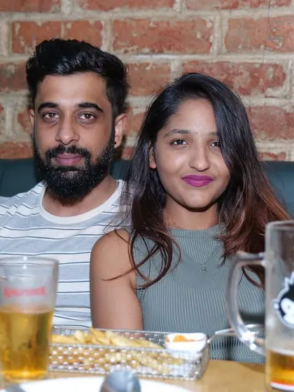 A couple having a casual evening with some drinks and snacks. It's a relaxed environment where you can unwind after a long day or week.