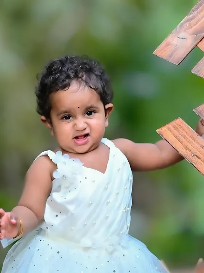 Another beautiful outdoor portrait of the same girl, showing her playful and expressive side.