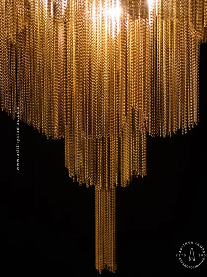 This chandelier makes a bold statement with its cascading antique gold chains. The layers of chains create a fluid, waterfall-like effect that beautifully diffuses the light, adding texture, warmth, and a touch of vintage glamour to your interior.