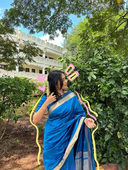 A beautiful blue saree moment, made even cuter with some pink hearts and yellow outlines.