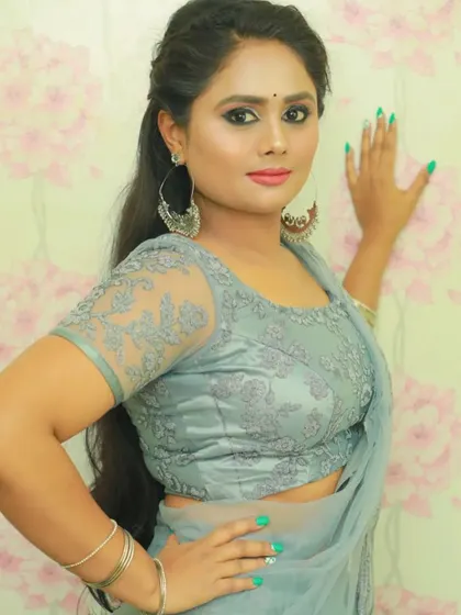 Another look at the grey designer saree, showing the detailed embroidery on the blouse and the soft drape of the fabric.