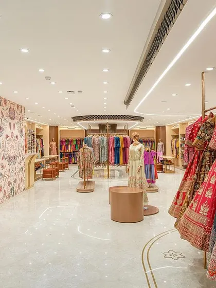 A view from the staircase landing on the ready-to-wear floor. The open layout and bright lighting create a spacious and inviting atmosphere for shoppers.