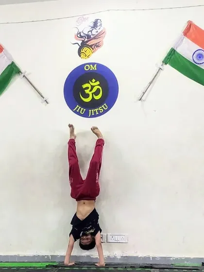 This young champion is practicing a handstand against the wall, building the strength and confidence to eventually do it unsupported.