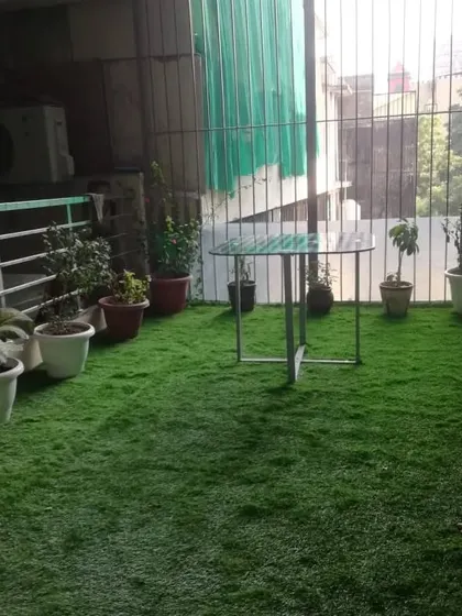 This view shows how the synthetic turf covers the entire floor area, creating a unified and tidy look. It's a simple change that makes a huge difference to your outdoor space.