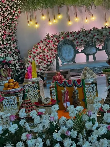 A grand platter display in front of a stage with beautiful lighting and floral decor.