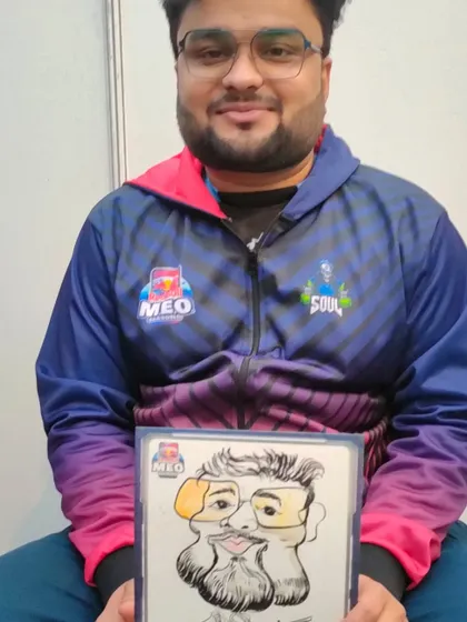 This participant in a Redbull MEO jacket proudly holds his personalized caricature.