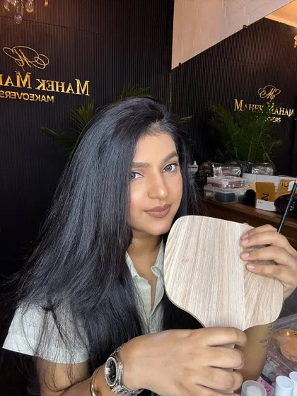 Holding up a mirror to show the final result of the simple party makeup.