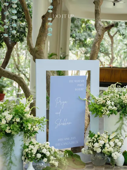 The welcome signage for the Mehendi party, styled with simple, elegant white and green floral arrangements. The clean design set a calm and sophisticated tone for the event.