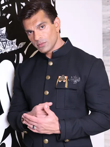 A confident and direct portrait of Karan Singh Grover, capturing his magnetic personality.