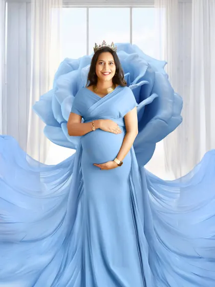 A stunning portrait using a giant fabric flower prop to create a fantasy look. The blue gown and matching blue rose make for a magical image.
