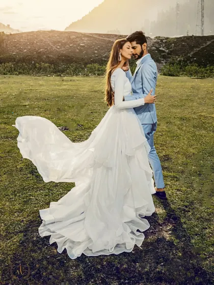 A stunning shot of a bride's dress flowing in the wind in a Kashmiri meadow. This image is the epitome of a fairytale pre-wedding moment, combining elegance and natural beauty.