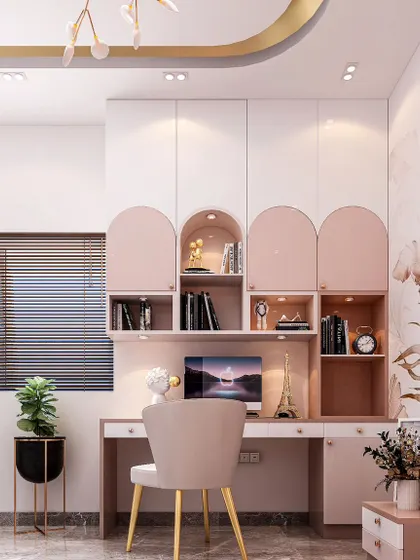 A closer look at the study area in this versatile bedroom. The desk is built into a custom cabinetry unit with a mix of open and closed storage, featuring soft pink and white tones with elegant arched details.