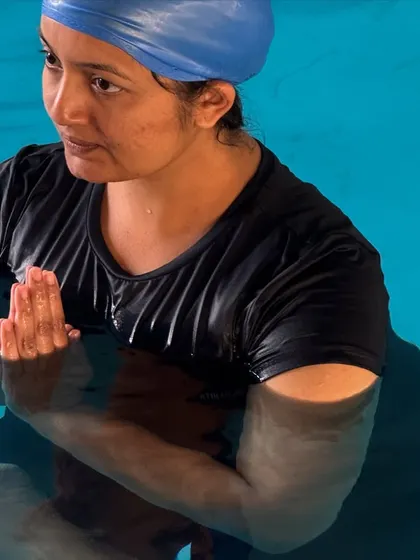 A participant in a seated meditative pose in the water. The support of the water allows for a comfortable and stable posture, making meditation more accessible.
