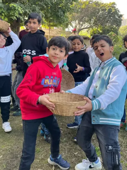 A playful moment between two boys with their harvesting baskets during a fun day out on the farm.