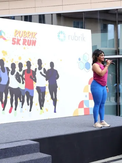 On the mic at the Rubrix 5K Run. My job is to get everyone's energy up, and I love every second of it.