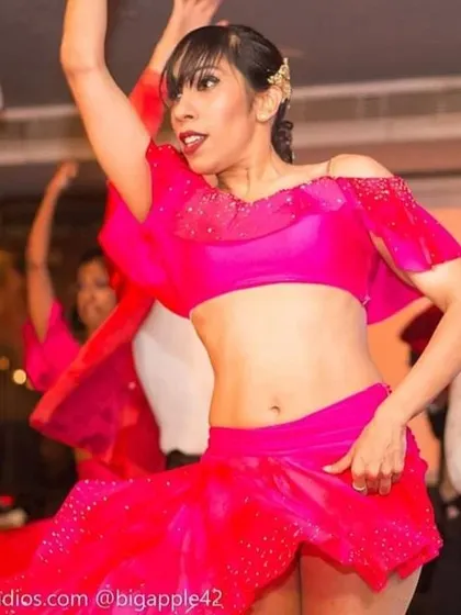 A vibrant group performance in action. The energy of dancing with a team is infectious, and we love bringing that colourful, coordinated joy to the stage in our Salsa and Bollywood numbers.