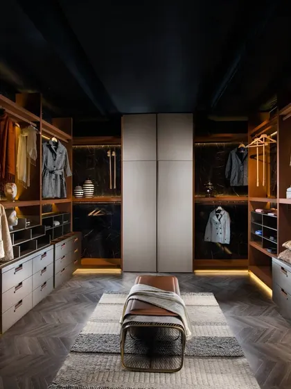 We believe a wardrobe should be a luxurious dressing space. This walk-in closet is designed with clean lines and warm, ambient lighting, featuring a mix of open shelving and drawer units to create a perfect, organized solution for your entire collection.