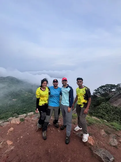 Our trek leaders posing with a group above a sea of clouds. We pride ourselves on creating unforgettable mountain experiences filled with connection and fresh air.