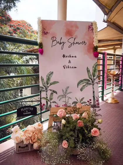 I also design decor for traditional baby shower ceremonies like a Shreemantham. This elegant welcome sign features a watercolor design and is flanked by fresh flowers, setting a graceful tone for the event.