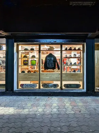 The full storefront at night, with each window bay acting as a carefully curated display.