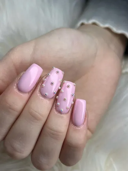 This "caviar" nail look is created by carefully placing dozens of tiny pearl beads over a soft pink base. It's a unique texture that's sure to be a conversation starter.