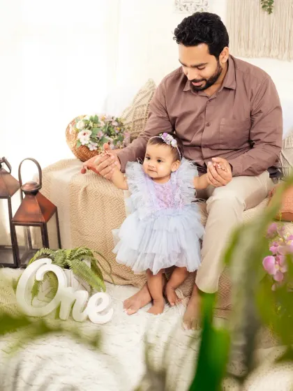 A tender moment between father and daughter as she takes her first steps into being one year old.