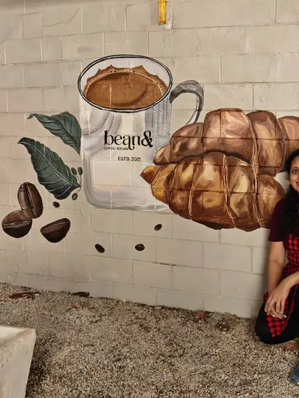 A mural designed for the outdoor area of 'bean&' cafe. This piece features their signature offerings, coffee and croissants, painted in a realistic style to create an appetizing and brand-centric visual.