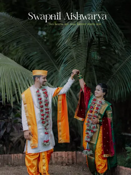 A celebratory pose with the couple raising their hands, perfectly capturing the joy of their union against a backdrop of palm trees.