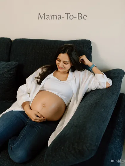 A beautiful smile from the mama-to-be, relaxing on her couch. In-home sessions are all about capturing real, comfortable, and love-filled moments.